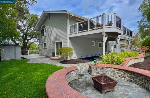 a view of a backyard with plants and outdoor seating