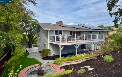 a aerial view of a house with yard swimming pool and outdoor seating