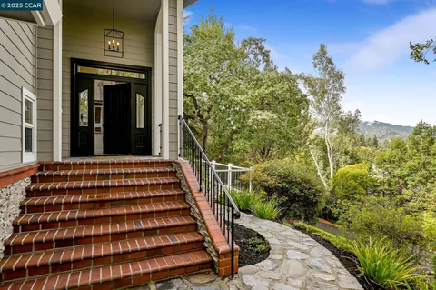 a view of a large building with large windows and plants