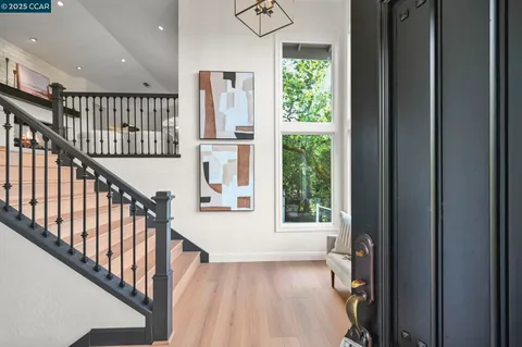 a view of an entryway with wooden floor