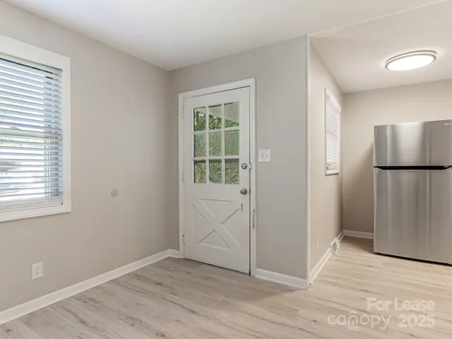 an empty room with windows and closet