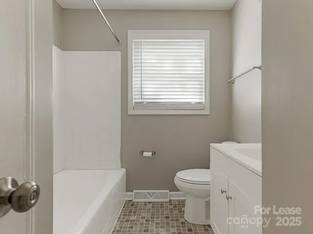 a bathroom with a toilet a sink and a bathtub
