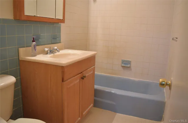a bathroom with a sink a toilet and bathtub