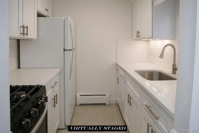 a kitchen with a refrigerator and a stove