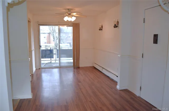 a view of a hallway with wooden floor and a chandelier