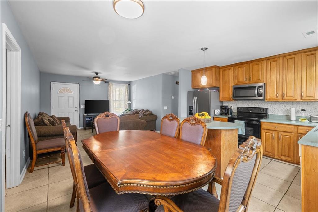 171 Bear Den Court Dalton, GA 30721 - Photo 11 of 30 a large kitchen with a table and chairs