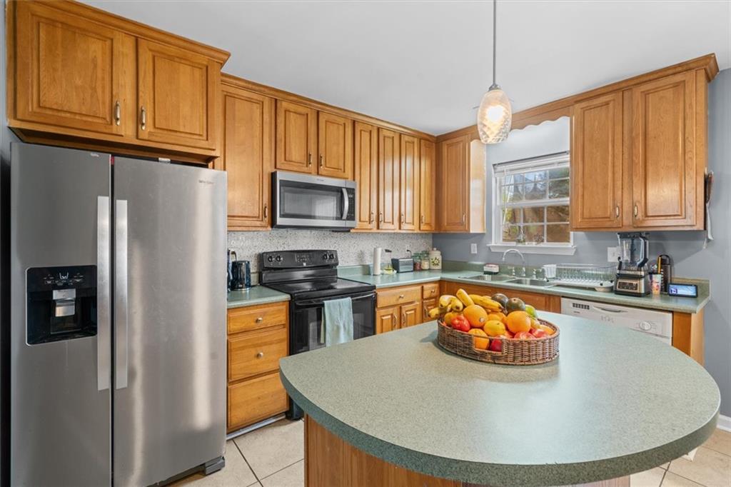 171 Bear Den Court Dalton, GA 30721 - Photo 13 of 30 a kitchen with stainless steel appliances granite countertop a refrigerator a stove top oven a sink and dishwasher