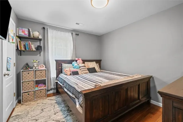 a bedroom with a bed and a book shelf