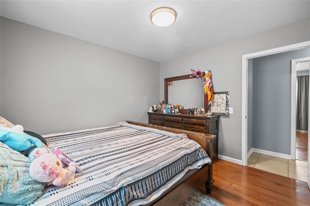 171 Bear Den Court Dalton, GA 30721 - Photo 21 of 30 a bedroom with a bed and wooden floor