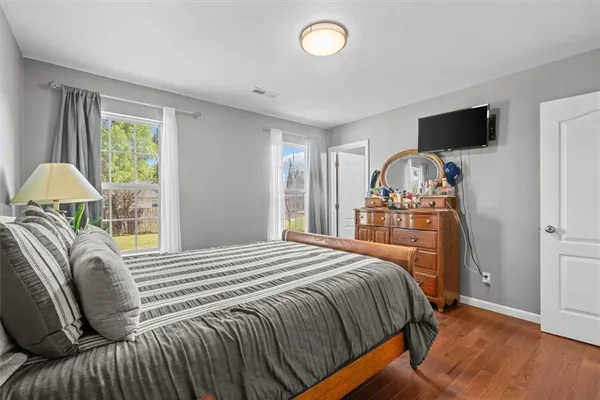 a bedroom with a bed and flat screen tv