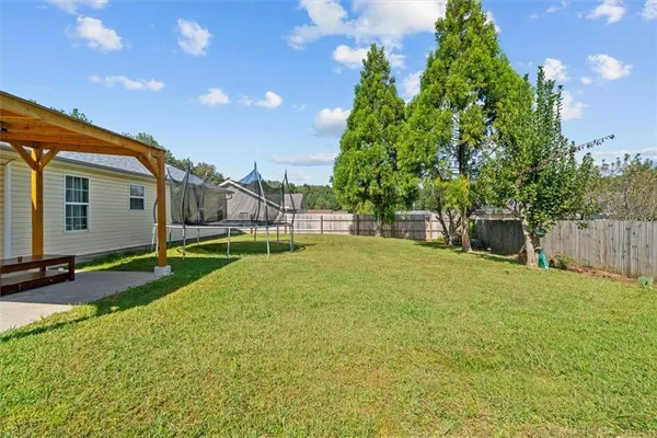 a view of backyard of house with green space
