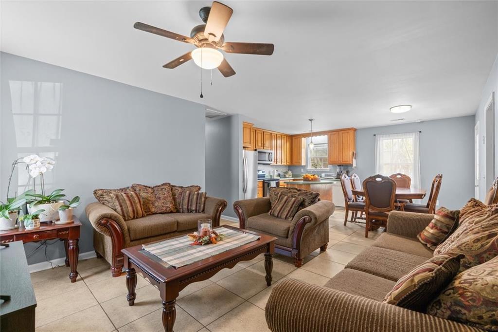 171 Bear Den Court Dalton, GA 30721 - Photo 7 of 30 a living room with furniture a ceiling fan and a rug