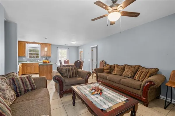 a living room with furniture ceiling fan and a rug