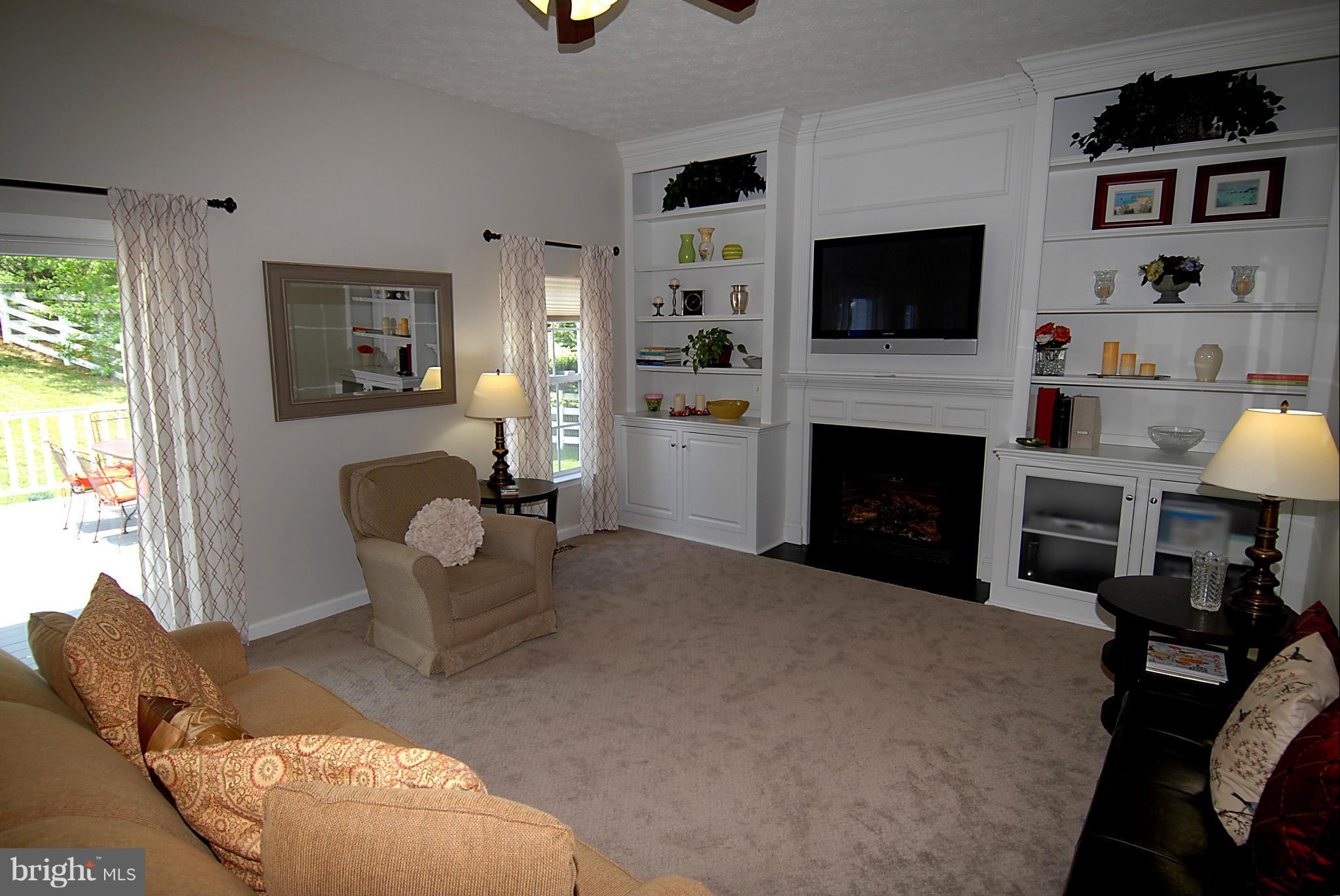 1200 Breckenridge Court Riva, MD 21140 - Photo 8 of 28 a living room with furniture a flat screen tv and a fireplace