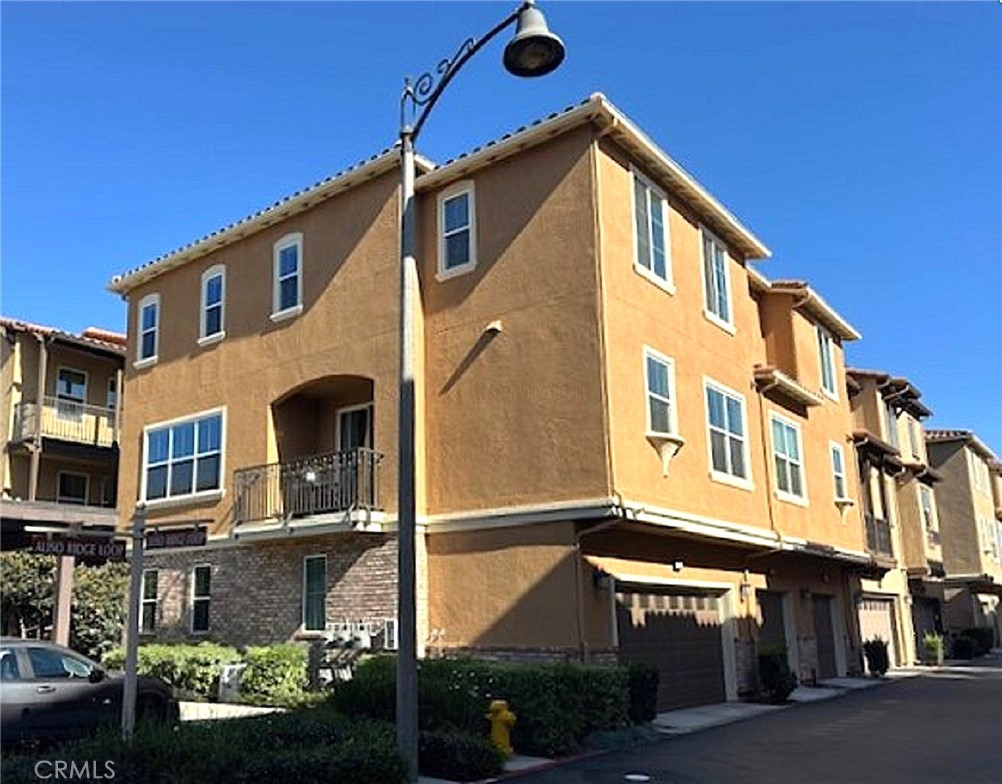 108 Aliso Ridge Loop Mission Viejo, CA 92691 - Photo 1 of 6 a front view of a building with street