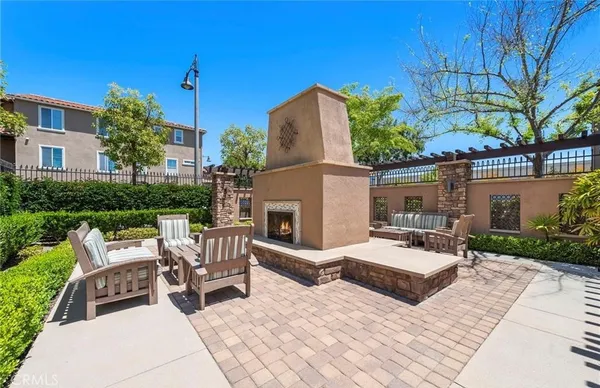 a view of a patio with couches table and chairs and potted plants