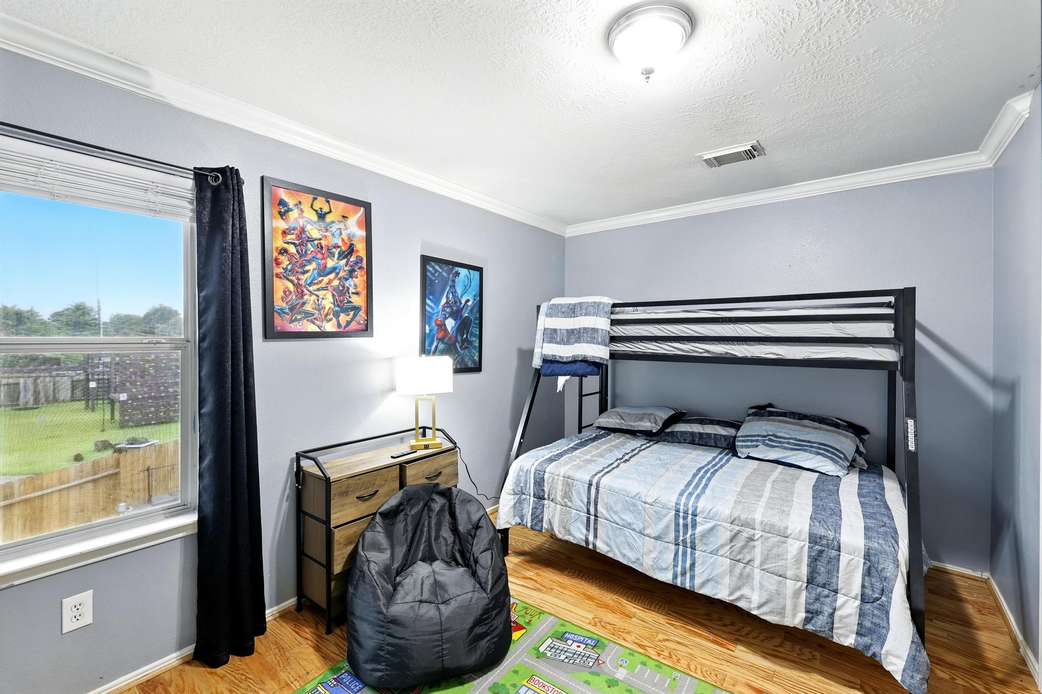 3002 Trinity Pass Court Spring, TX 77373 - Photo 21 of 22 This versatile secondary bedroom features durable wood flooring, a wide window with backyard views, with space for flexible furniture arrangements.