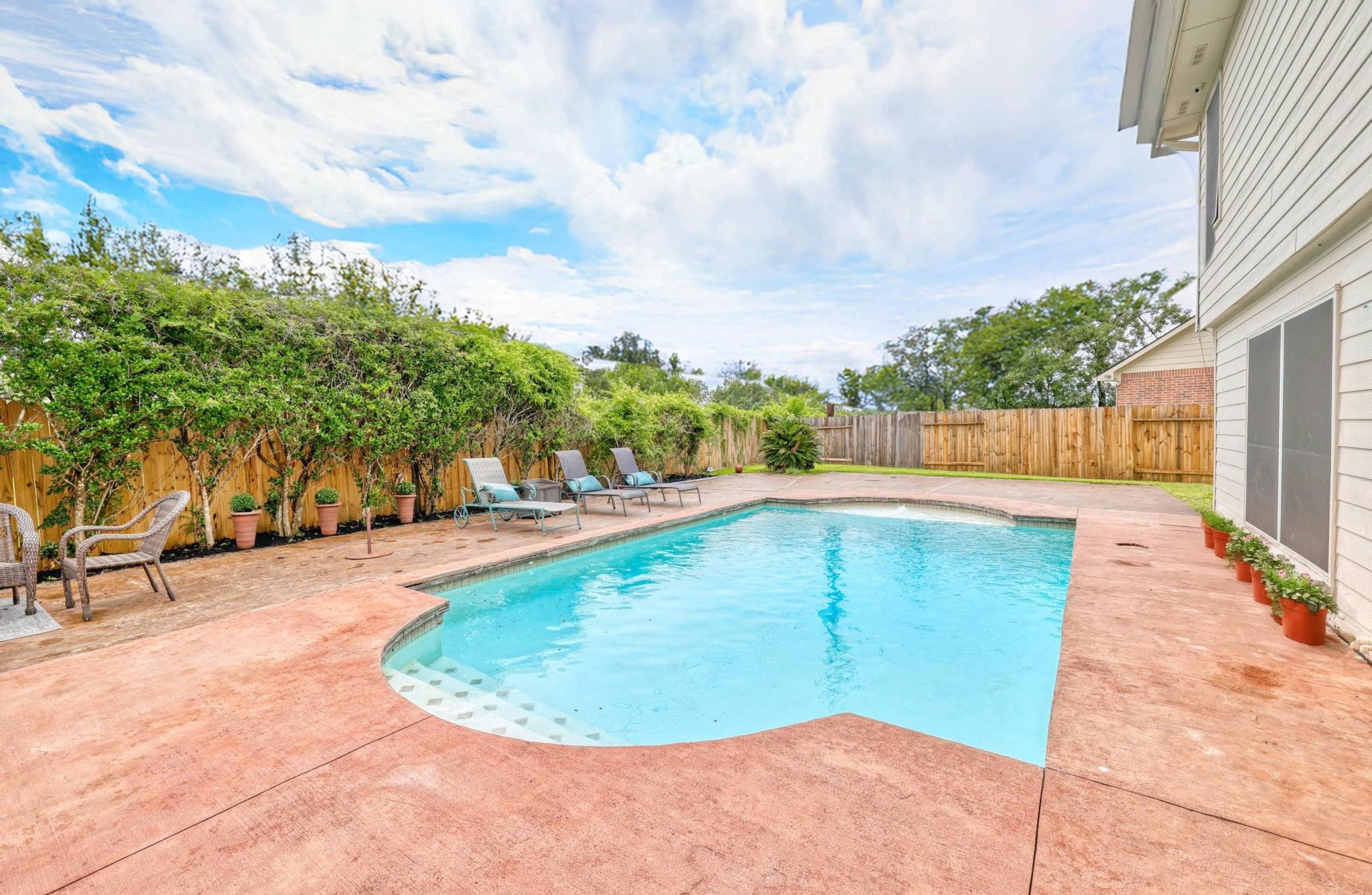 3002 Trinity Pass Court Spring, TX 77373 - Photo 22 of 22 The sparkling pool is the highlight of the private backyard oasis, surrounded by lush greenery and privacy fencing. Ample deck space and multiple lounging areas make it ideal for relaxing or hosting summer gatherings.