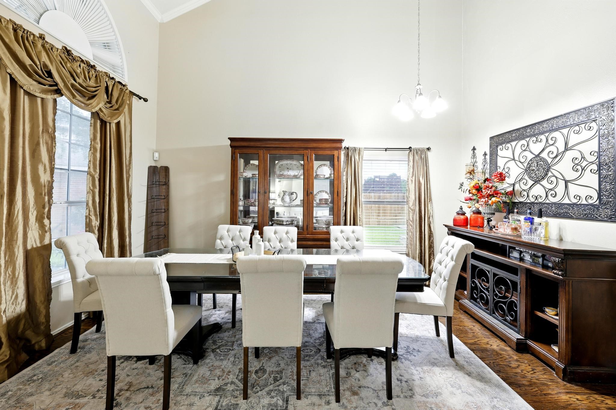 3002 Trinity Pass Court Spring, TX 77373 - Photo 4 of 22 Light-filled dining room features tall windows, chandelier, and space for a large dining set, ideal for entertaining.
