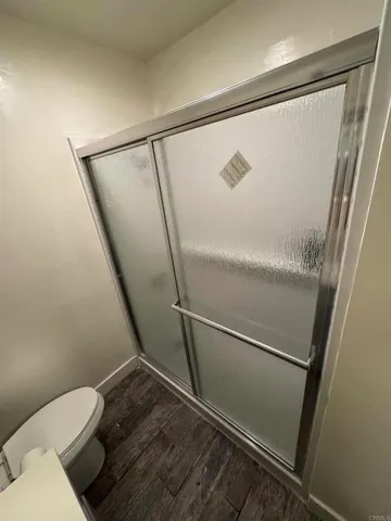 a bathroom with a toilet and a shower
