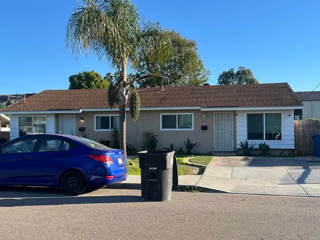 a front view of a house with parking space