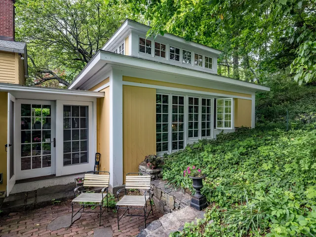 a front view of a house with a garden