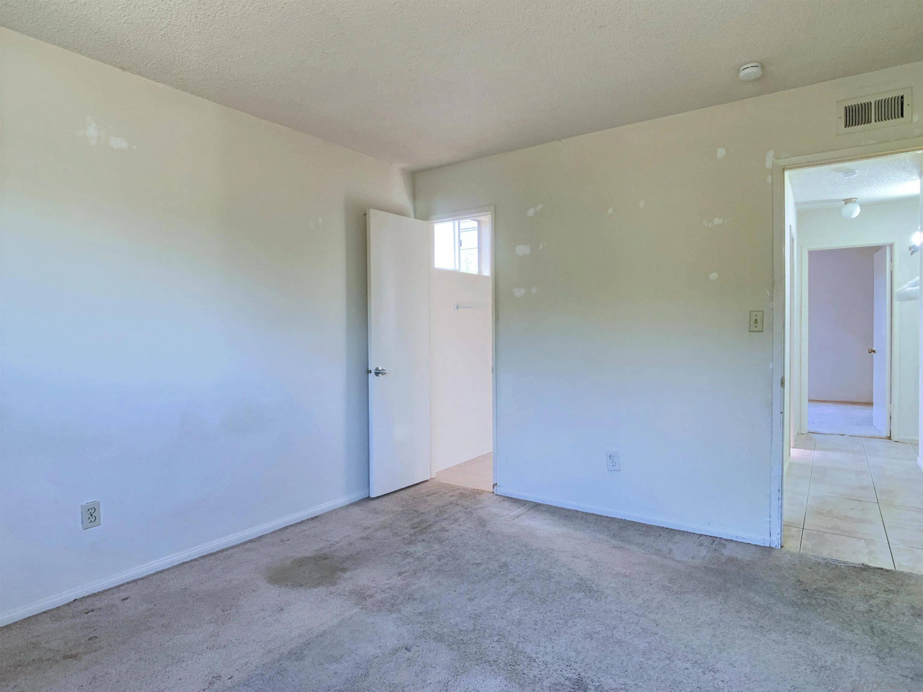 9443 Pebble Beach Drive Santee, CA 92071 - Photo 13 of 16 an empty room with wooden floor and windows