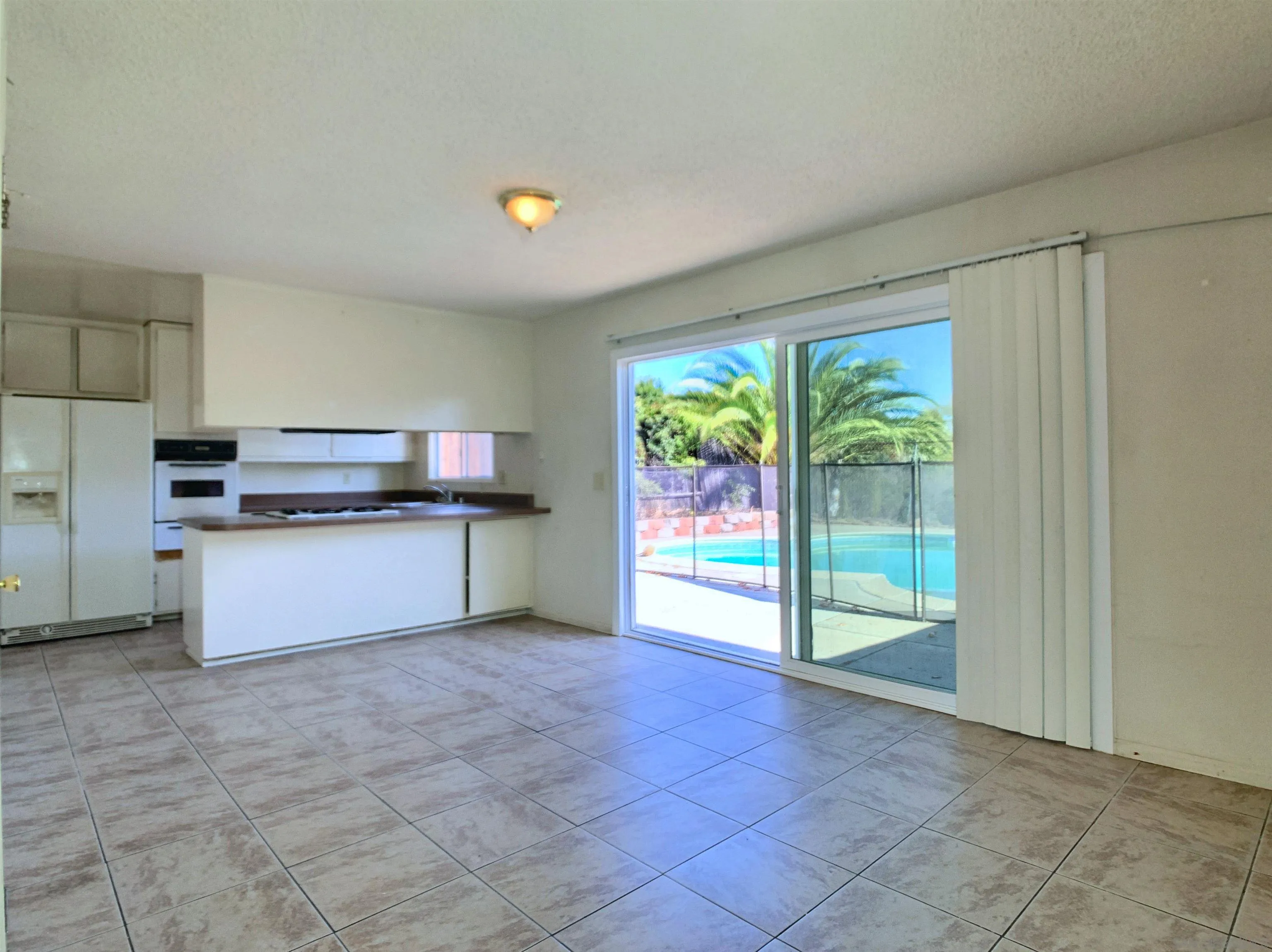 9443 Pebble Beach Drive Santee, CA 92071 - Photo 4 of 16 a kitchen with stainless steel appliances granite countertop a stove a sink and a refrigerator