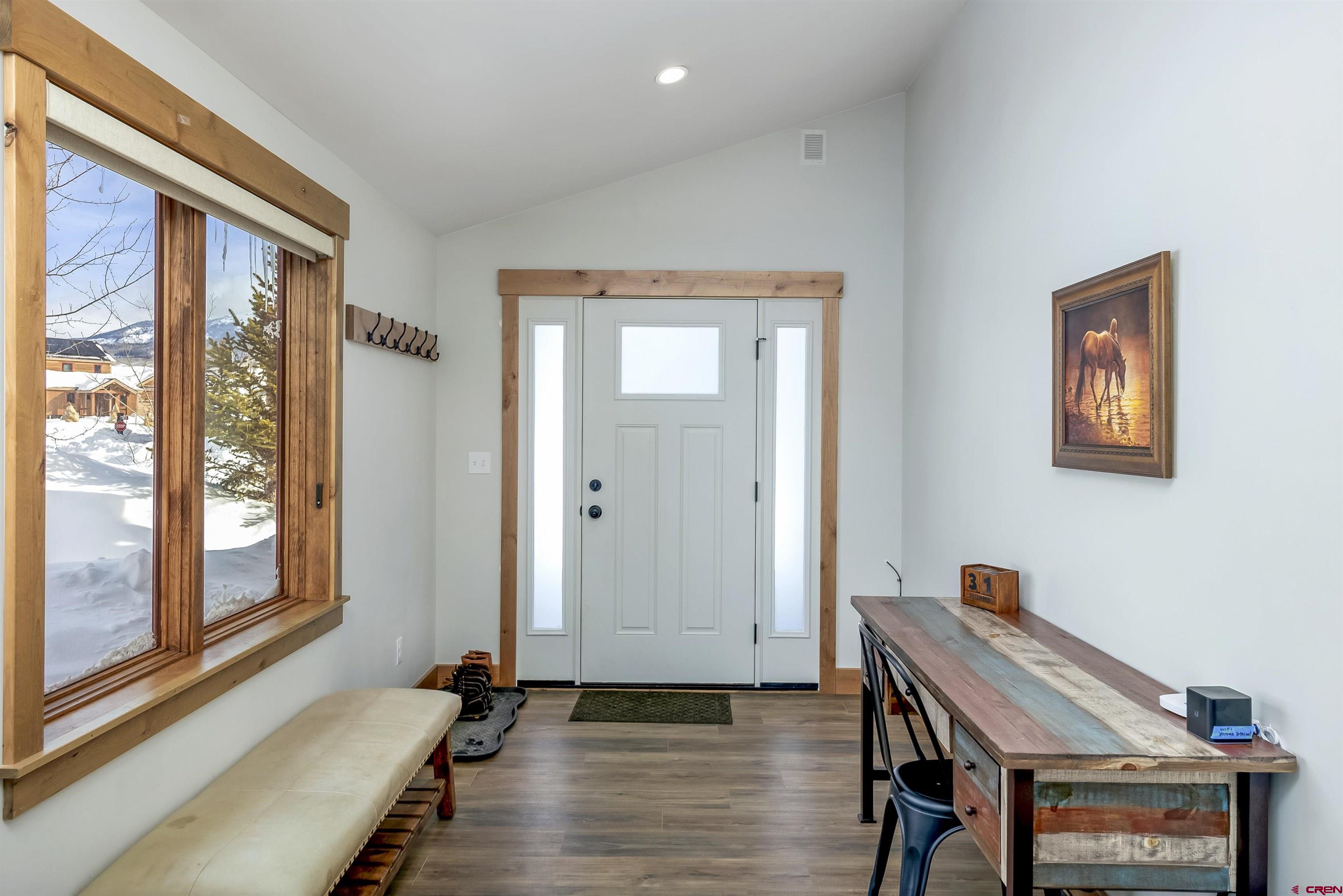 48 Elk Valley Road, Unit B Crested Butte, CO 81224 - Photo 11 of 34 a hallway with front door wooden floor and a front door