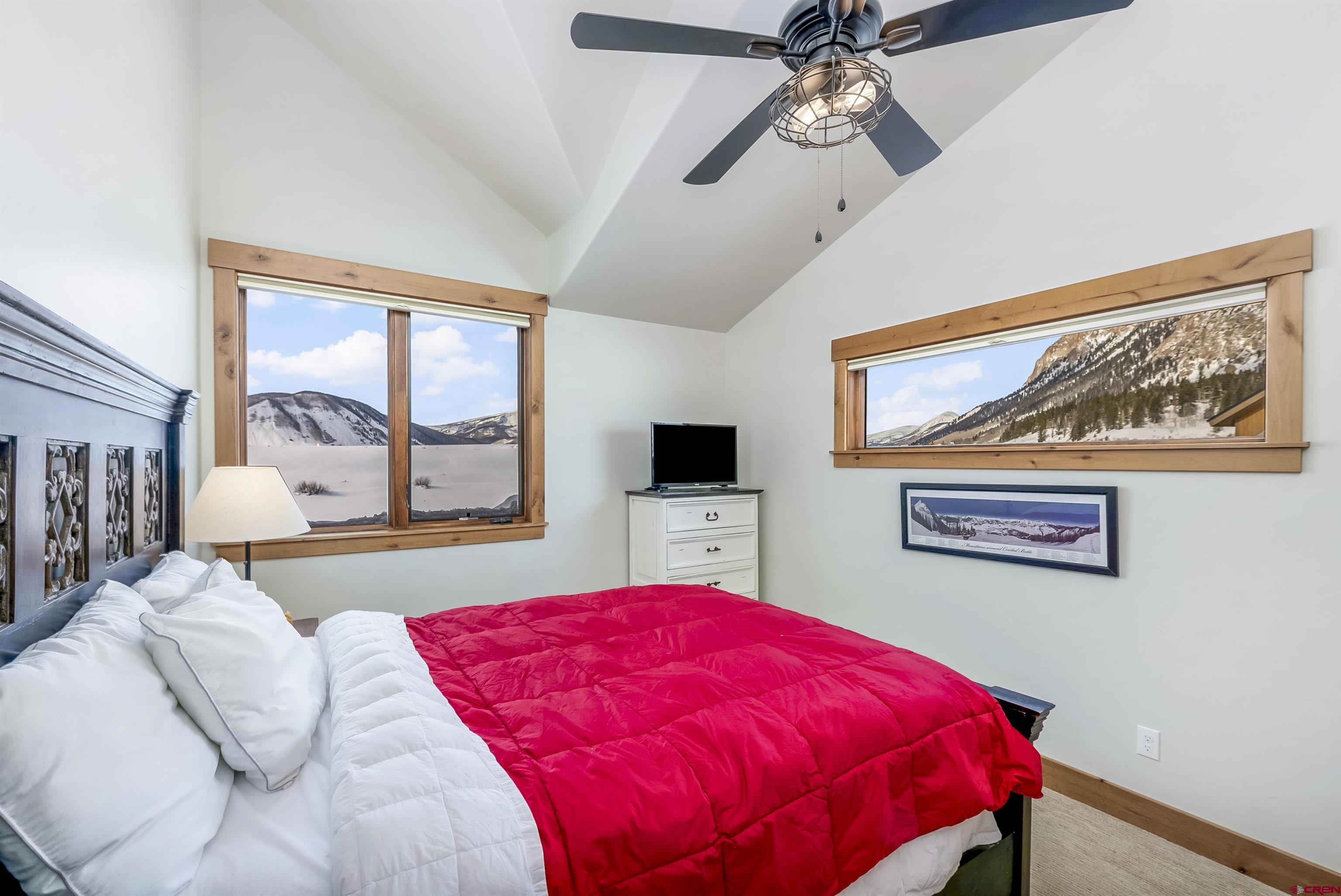 48 Elk Valley Road, Unit B Crested Butte, CO 81224 - Photo 15 of 34 a bedroom with a large bed and a flat screen tv