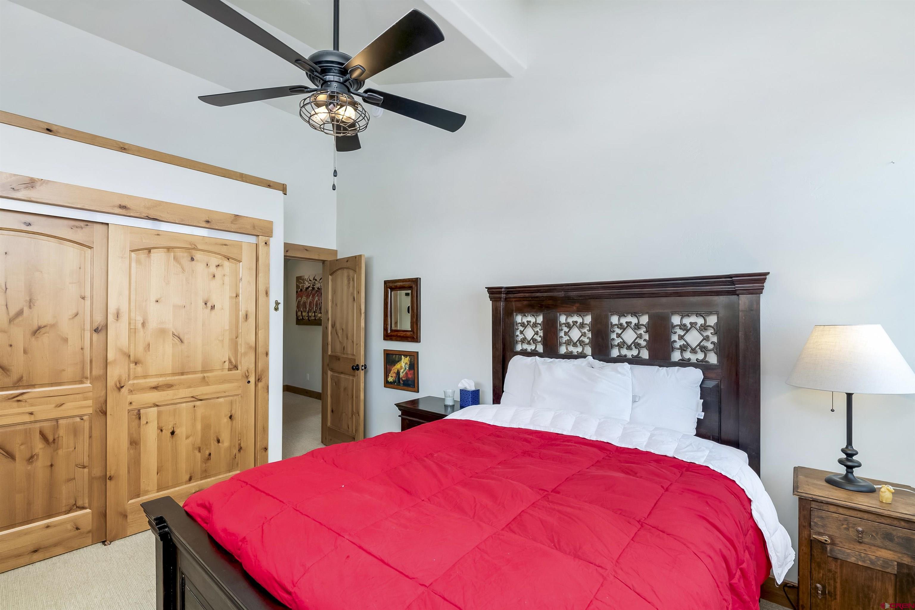 48 Elk Valley Road, Unit B Crested Butte, CO 81224 - Photo 16 of 34 a bed room with a bed and a lamp