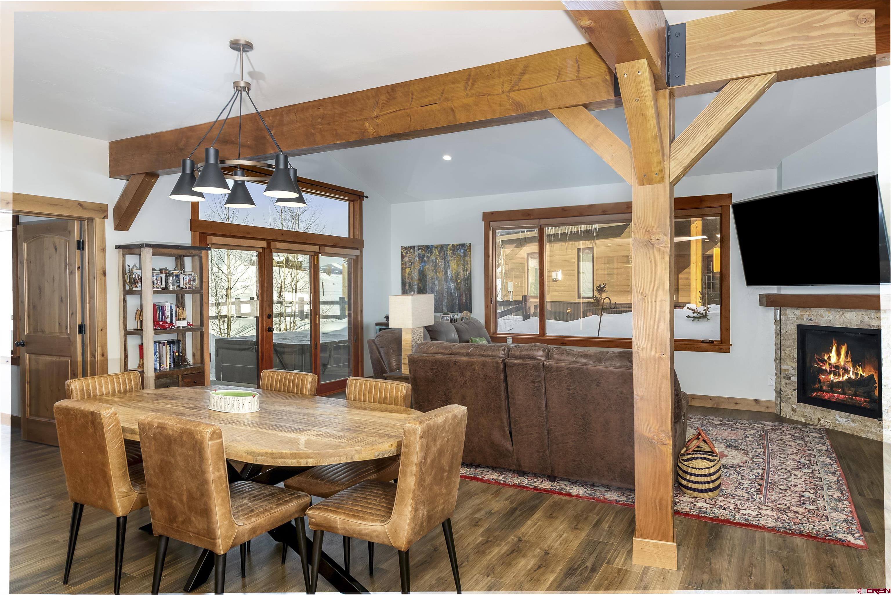 48 Elk Valley Road, Unit B Crested Butte, CO 81224 - Photo 8 of 34 a dining room with furniture a chandelier and wooden floor