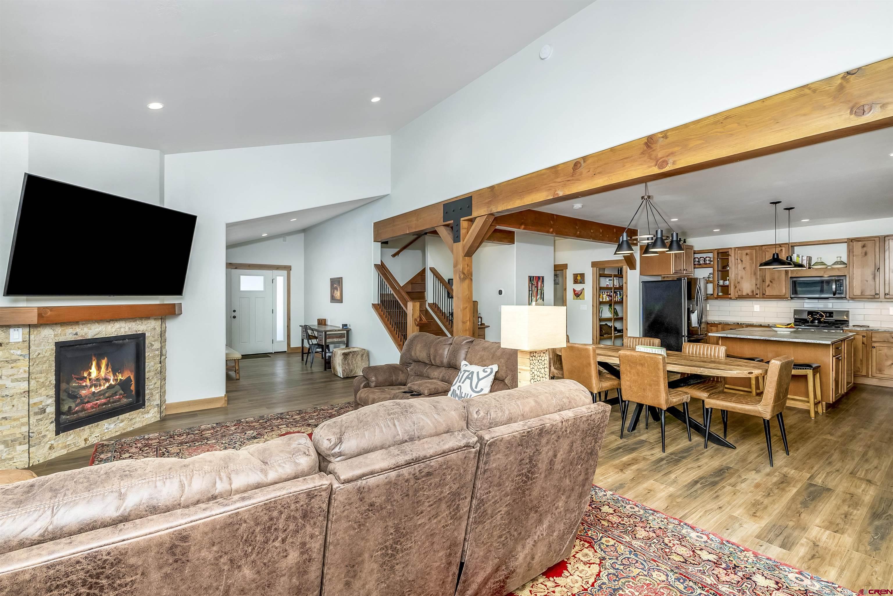 48 Elk Valley Road, Unit B Crested Butte, CO 81224 - Photo 10 of 34 a living room with furniture a flat screen tv and a fireplace