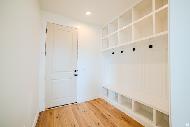 223 South Cottonwood Road, Unit 7501 Vineyard, UT 84059 - Photo 34 of 45 Entryway mudroom featuring built-in white cabinetry with storage cubbies, bench seating, and coat hooks