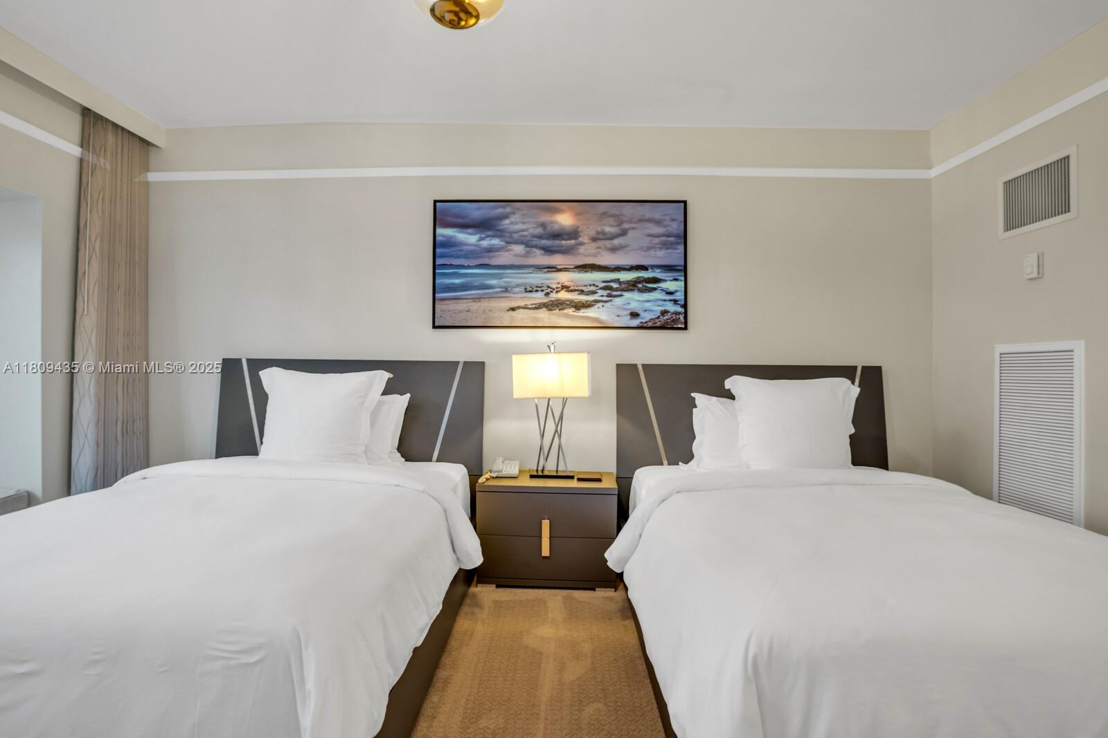 1435 Brickell Avenue, Unit 3012 Miami, FL 33131 - Photo 25 of 73 a bedroom with double bed and a night stand