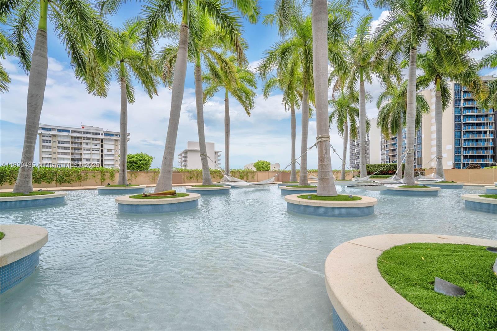 1435 Brickell Avenue, Unit 3012 Miami, FL 33131 - Photo 67 of 73 a view of swimming pool with chairs and palm trees