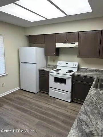 a kitchen with a stove and a refrigerator