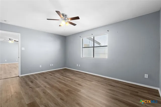wooden floor in an empty room with a window