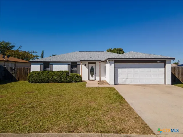 a front view of a house with yard