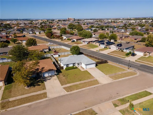an aerial view of residential houses with outdoor space