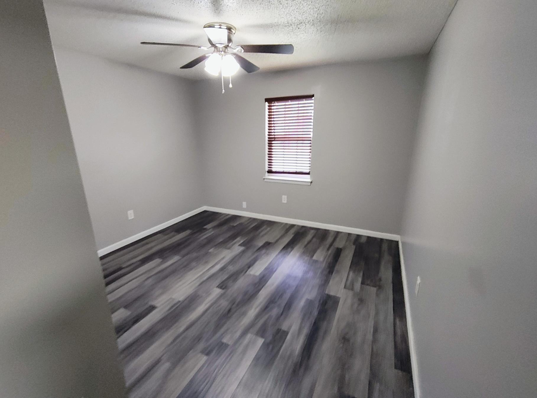 858 Pendleton Street Memphis, TN 38114 - Photo 3 of 10 wooden floor in an empty room with a window