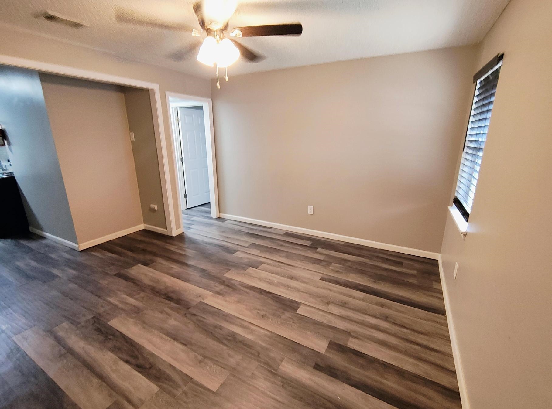 858 Pendleton Street Memphis, TN 38114 - Photo 6 of 10 a view of room with wooden floor and ceiling fan