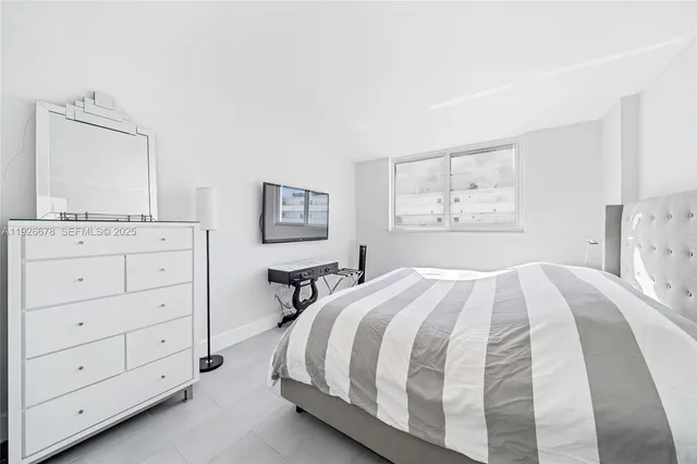 a spacious bedroom with a bed and a dresser