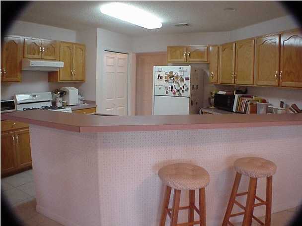 4462 Kingslynn Road Niceville, FL 32578 - Photo 7 of 15 a kitchen with stainless steel appliances granite countertop a sink a stove and a refrigerator