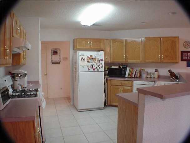 4462 Kingslynn Road Niceville, FL 32578 - Photo 8 of 15 a kitchen with a refrigerator and a sink