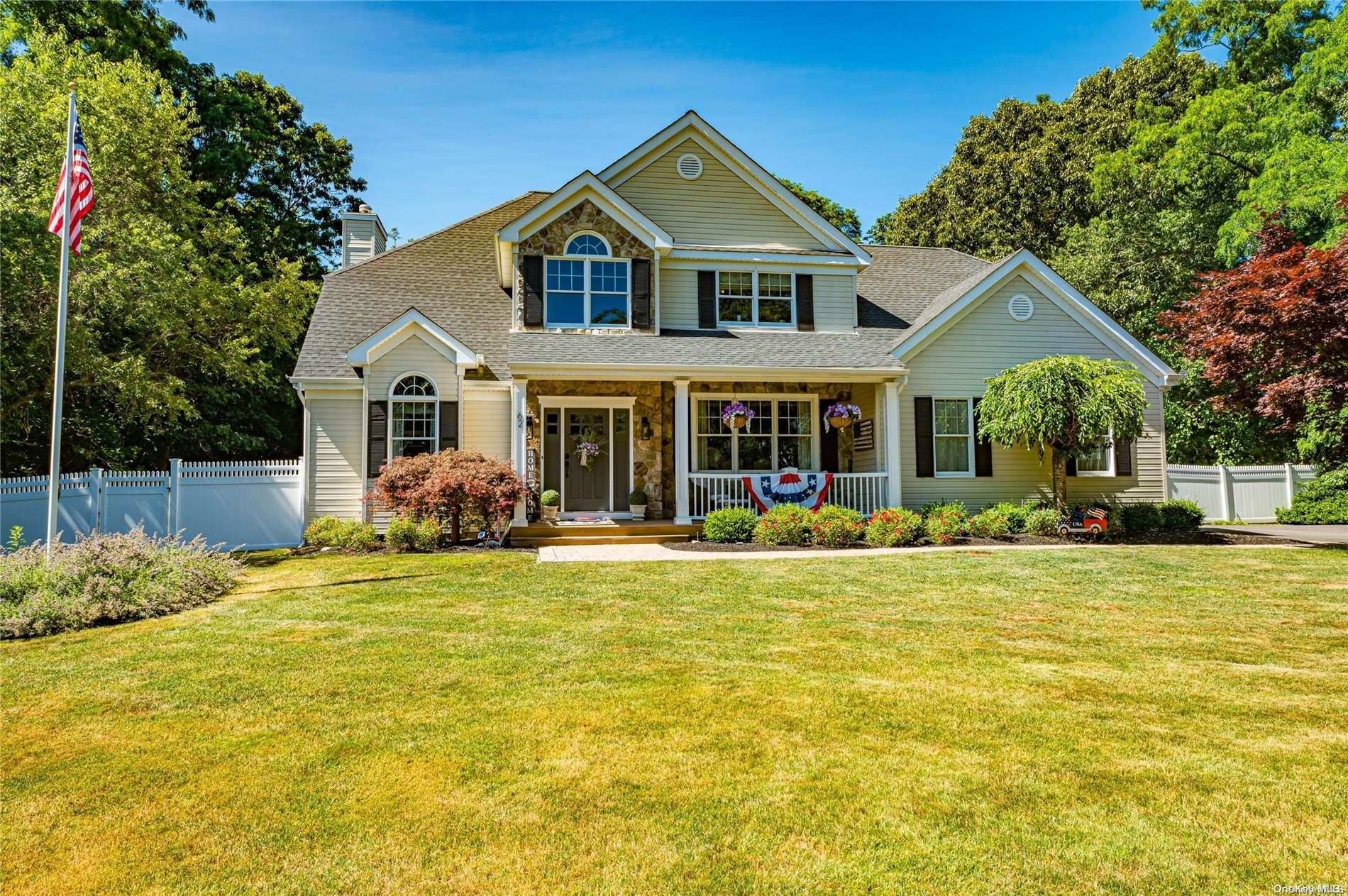 a front view of a house with swimming pool and porch with furniture
