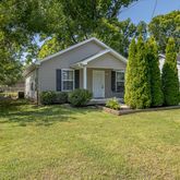 a view of a house with backyard and garden