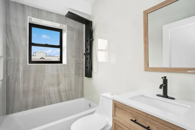 a bathroom with a toilet sink and shower