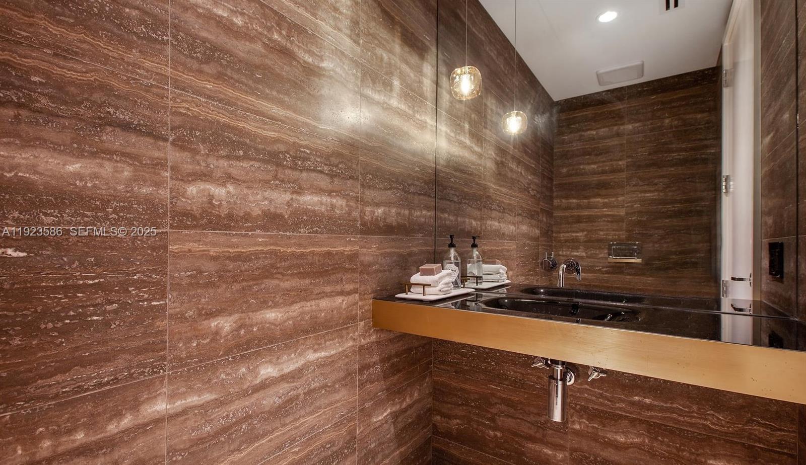 300 Collins Avenue, Unit PH2 Miami Beach, FL 33139 - Photo 7 of 21 a bathroom with a sink and a mirror