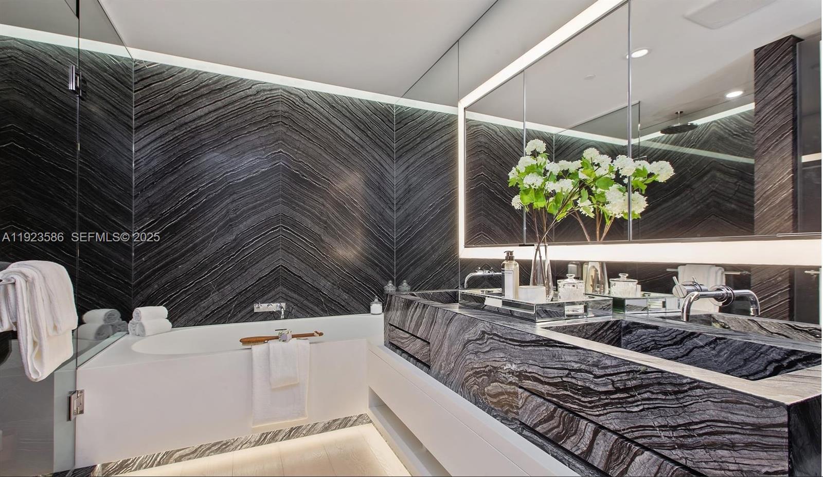 300 Collins Avenue, Unit PH2 Miami Beach, FL 33139 - Photo 9 of 21 a kitchen view with a sink and stove